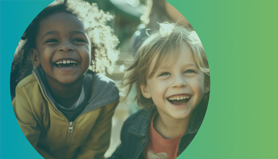 Image of two young children laughing together, framed within a large circular crop against a soft teal-to-green gradient background. The natural light highlights their joyful expressions and sense of friendship, creating a warm, uplifting feel that conveys inclusion, optimism and positive outcomes for children and families.