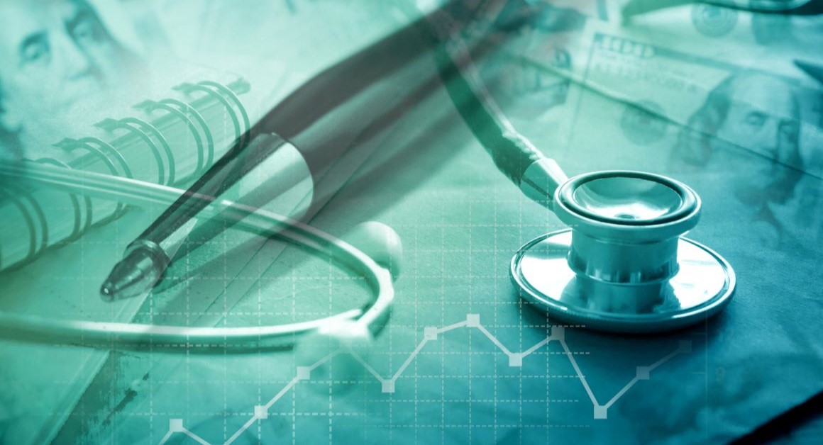 A teal-toned abstract image showing a stethoscope and pen overlaid with financial imagery, including banknotes and a line graph, symbolising the relationship between healthcare and funding or economics.